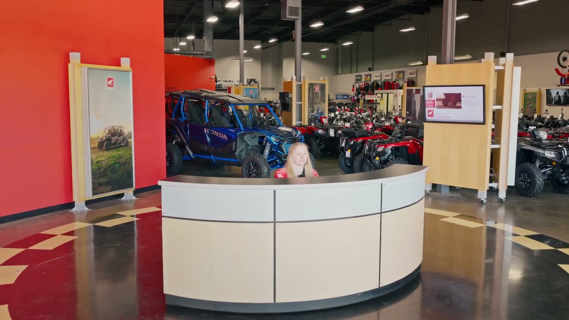 Honda motorcycles and side-by-sides lined up outside the Roseville Honda Motorsports service bays